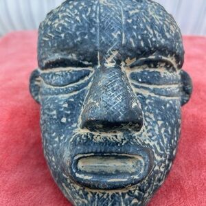 Black and Gray Sculptural Face Carving